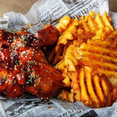 Chicken wings in sweet sauce, with waffle fries.