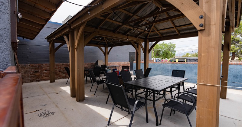 Roof covered patio area, tables and seats