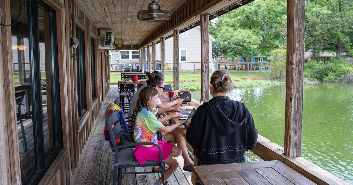 Exterior, terrace above water, tables, chairs, guests