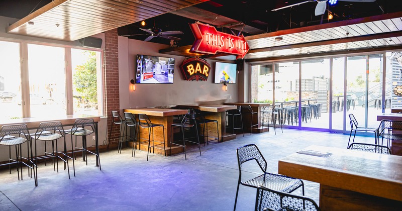 Interior, bar tables and stools, TVs on the wall