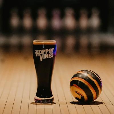 A glass of stout and a bowling ball.