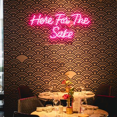 Diner table, light sign on the wall above.