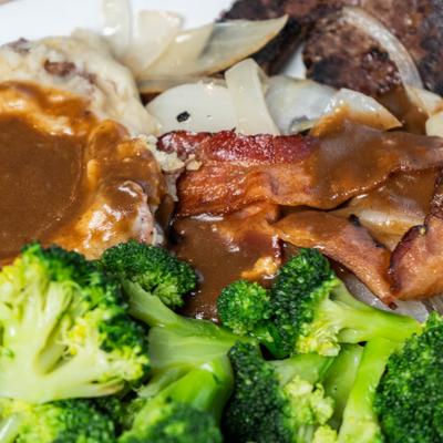 Liver, onions, bacon, beef gravy, mashed potatoes, and broccoli.