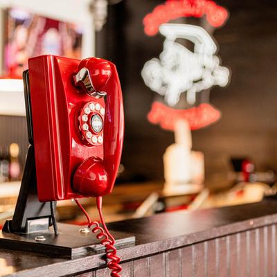 A vintage red telephone.
