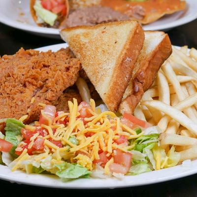 Fried chicken with toast, fries, and salad.