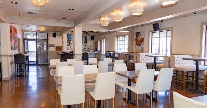 A modern dining area with white chairs and tables