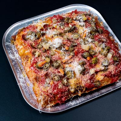 Diavola focaccia pizza served on a metal tray.
