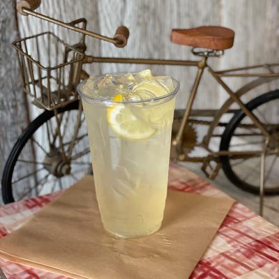 Lemonade served in a plastic cup with lemon slices.