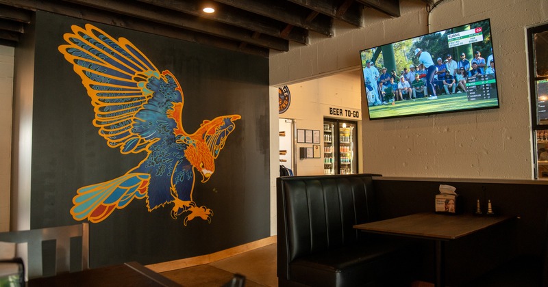 Interior, booths, tables, tv screen above