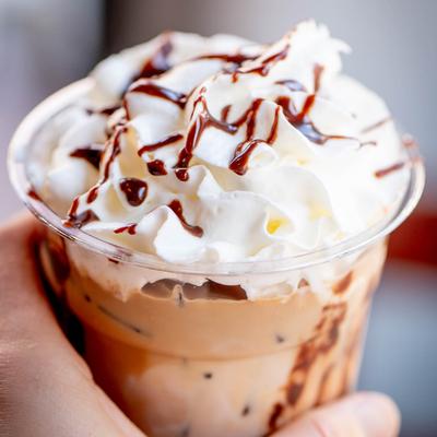 Nutella Iced Coffee cup in hand, close up.