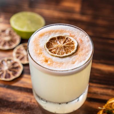 Pisco Sour garnished with a dry lime wheel.