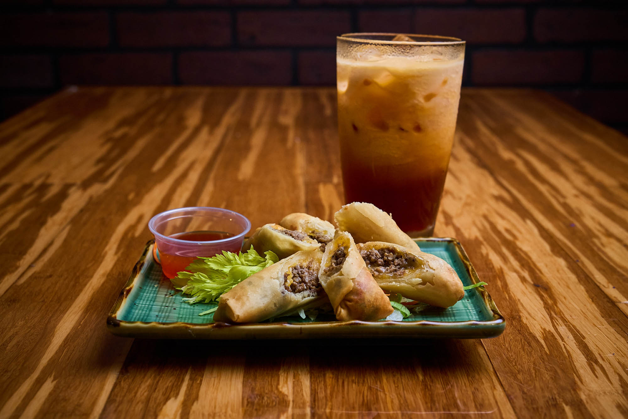 Egg roll plate and a glass of Thai ice tea