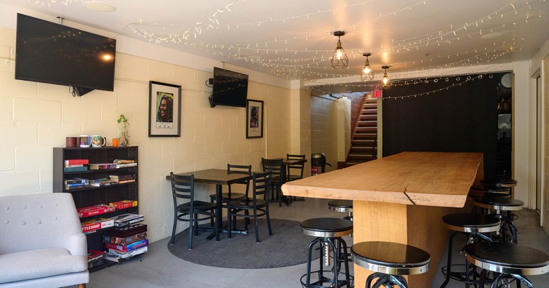 Interior, seating area, large high seating community table for ten, low book shelf