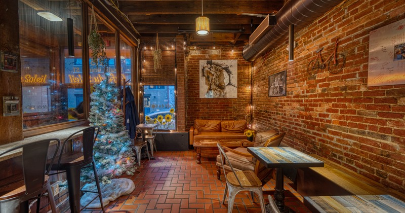 Interior, seating area, tables for two, two-seater sofa with an armchair and a coffee table