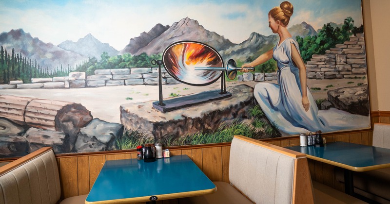 Restaurant booths next to a drawn wall