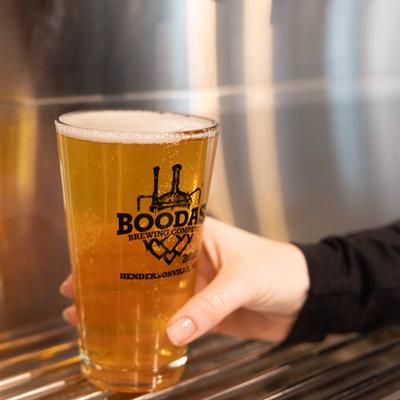 A pint glass of beer from Boodas.