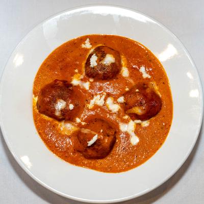 Deep-fried minced vegetable balls served in a creamy tomato sauce