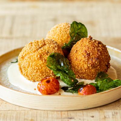 Deep fried rice balls coated with bread crumbs served