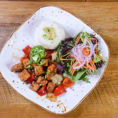 A plate of tofu stir-fry, rice, and mixed salad.
