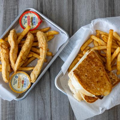 Chicken tenders and grilled cheese sandwich served with fries and dipping sauces.