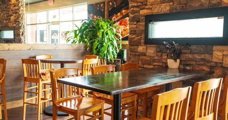 Interior, seating area with bar tables and stools