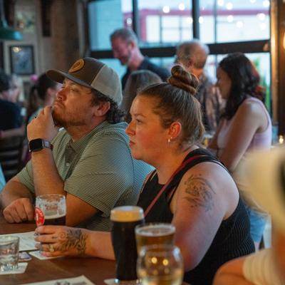 Customers sitting at the bar.