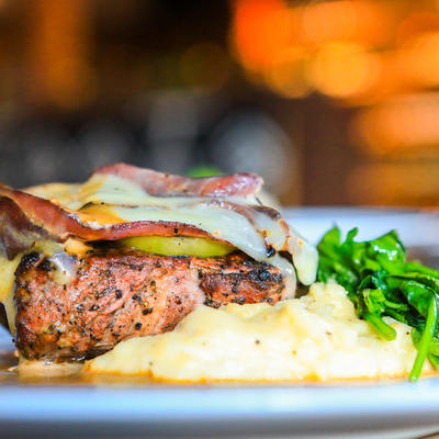 Grilled meat with melted cheese and salad