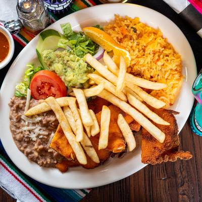 Breaded and fried chicken cutlets served with fries, rice, beans, and guacamole.
