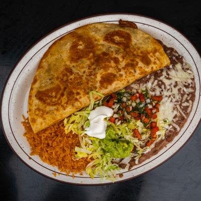 Fajita quesadilla served with rice, beans, guacamole, sour creme and pico de gallo.