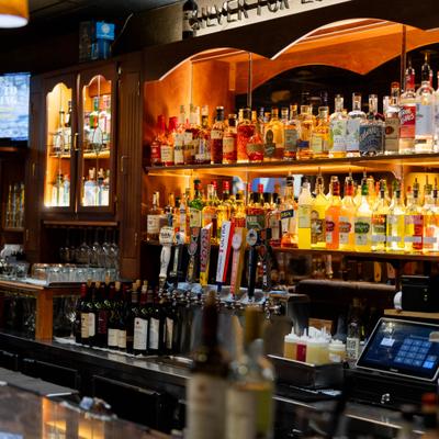 Backlit bar with liquor bottles and beer taps.
