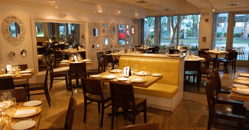 Interior, elegant dining area with leather benches, tables and chairs