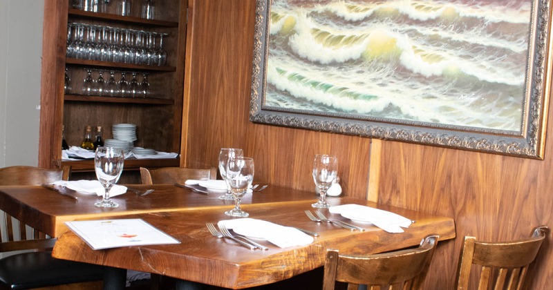 Interior, tables with tableware and chairs