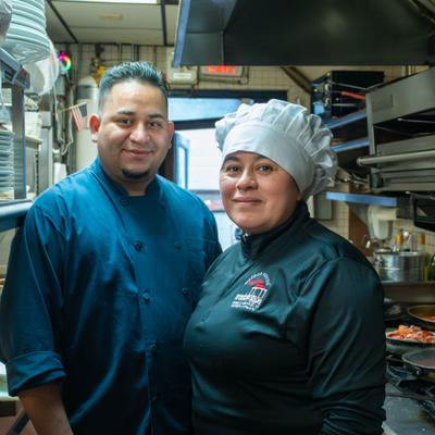 Chefs posing in the kichen.