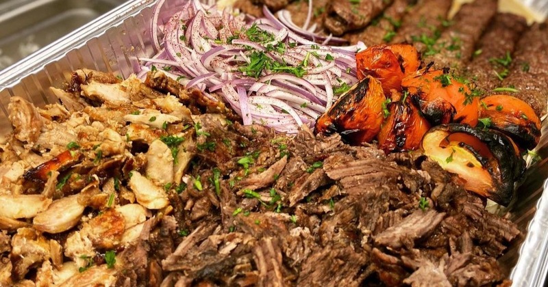 Assorted meats with grilled tomatoes and red onions