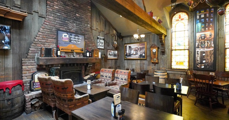 Interior, seating area, tables with chairs, armchairs with coffee tables, built in fireplace