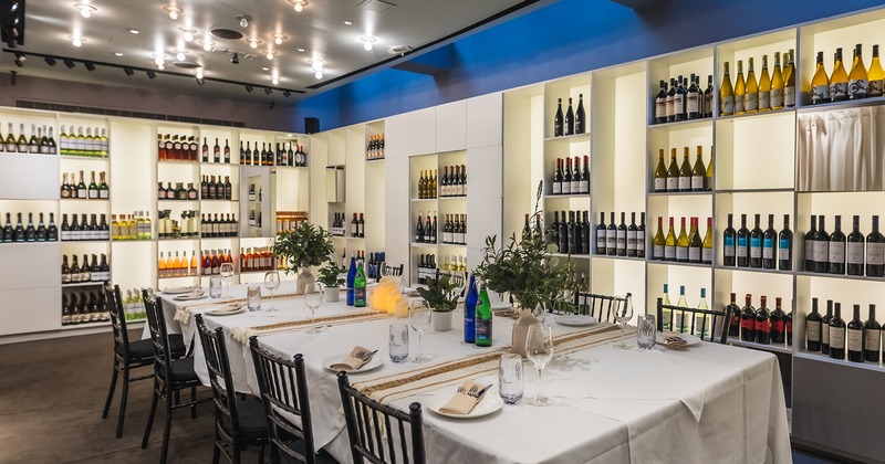 Private dining room with set table and wine racks