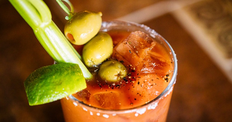 Orange cocktail with olives