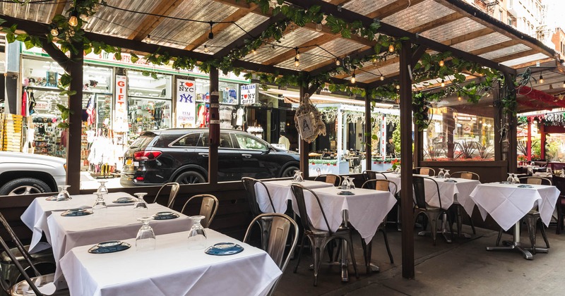 Exterior, covered dining area, tables and chairs ready for guests, lantern decoration