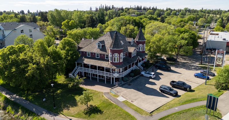 Aerial shot of restaurant with  the surroundings. Parking lot and forest.