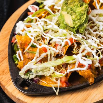 Pinto beans, cheddar cheese, lettuce, tomato, pico de gallo, guacamole, sour cream.