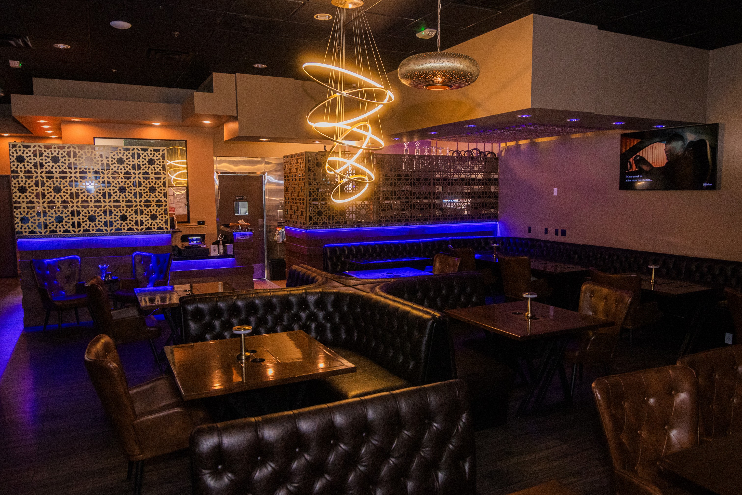 Interior with modern lighting and decor, booths, tables and charis