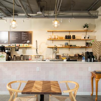 Cafe interior with tiled counter, menu board, and modern seating.