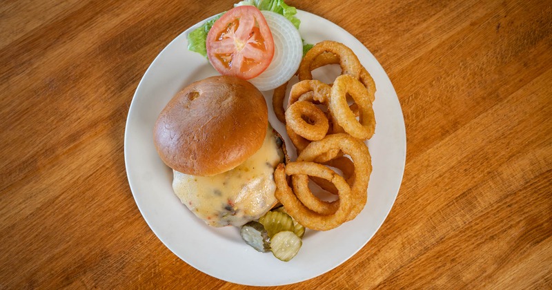 Big stick burger with onion rings on the side