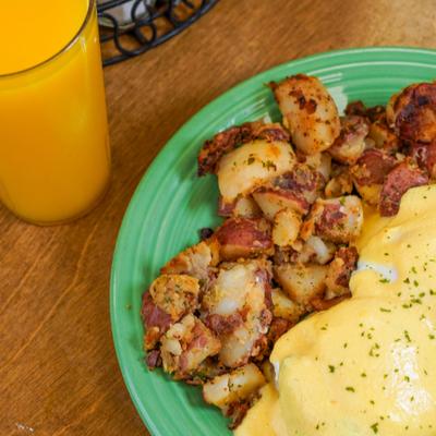 eggs benedict with side of home fries.