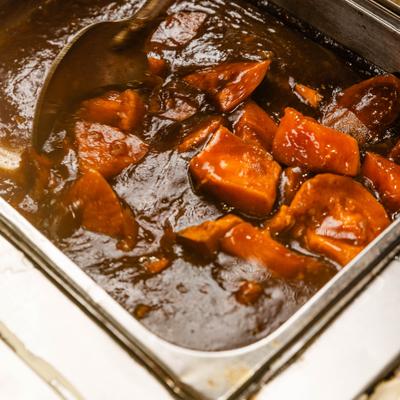 Candied sweet yams served in a chafing dish.
