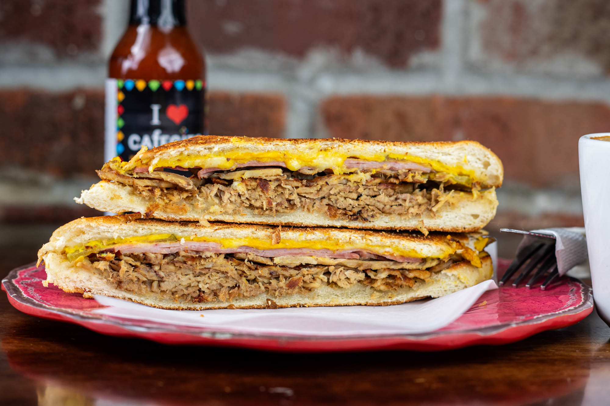 Cuban sandwich, with roasted pork, ham, Swiss, pickles, and mustard
