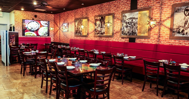 Interior, dining area, wooden tables and chairs, banquette seating in the back