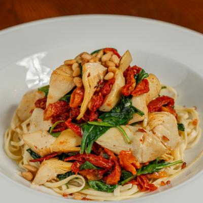 Limone pasta with sundried tomatoes, artichokes, spinach and roasted pine nuts.