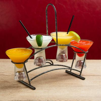 Margarita flight set on a light wooden table with a red background.