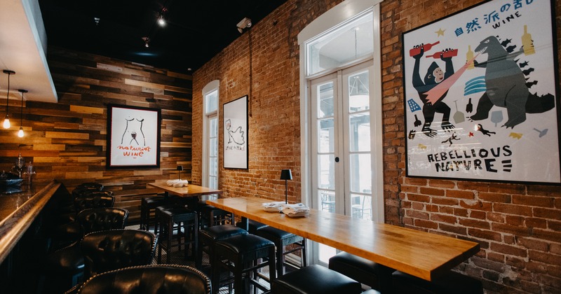 Modern and cozy restaurant interior, high tables and stools near the bar